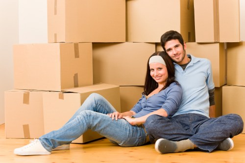 Local movers transporting dining furniture in a Streatham home